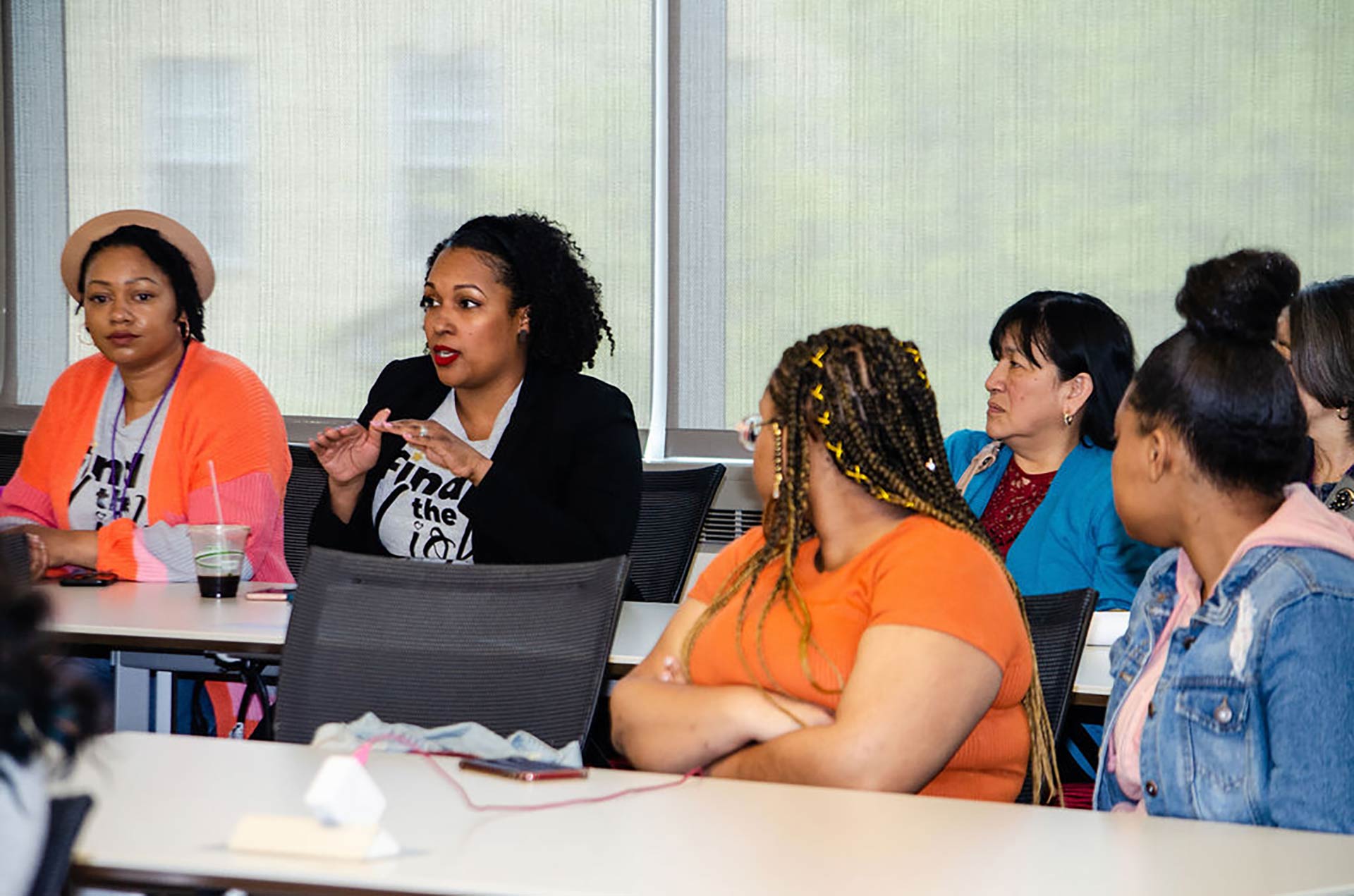 group of women listening at tables at workshop